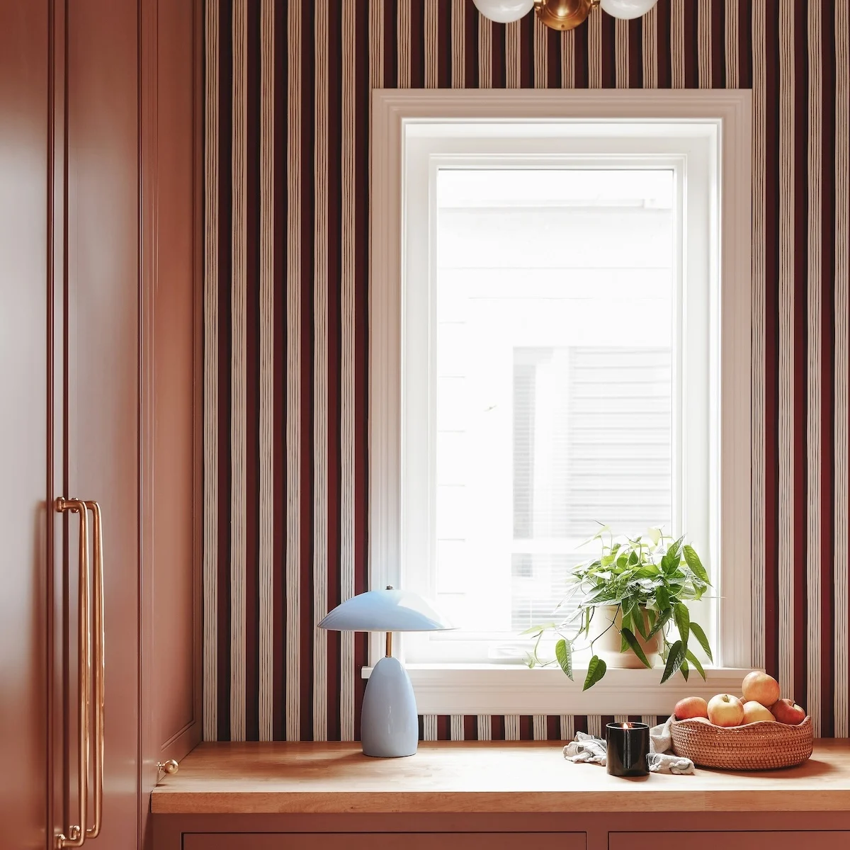 Pantry with striped wallpaper and window