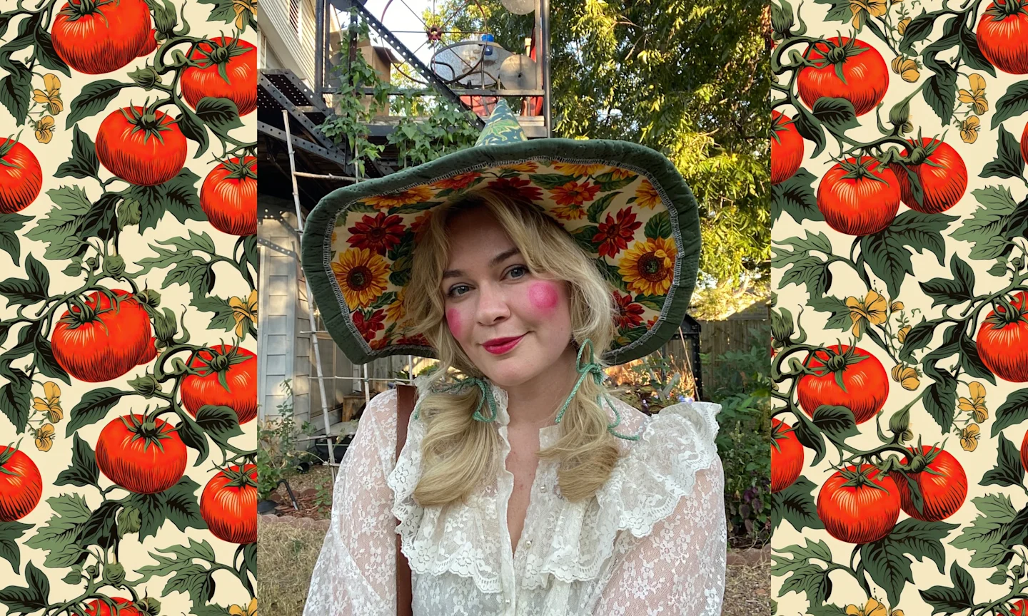 a woman in a white shirt with ruffles. she is wearing a witch hat made from fabric with sunflowers on it. 