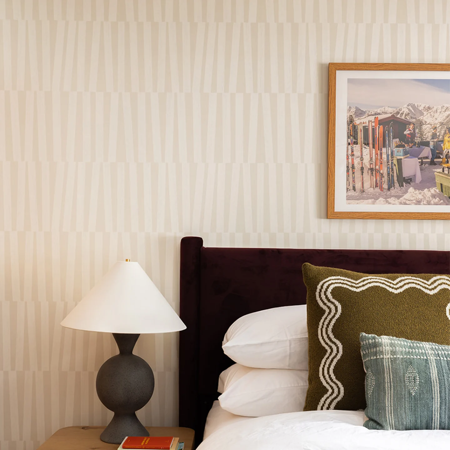Bedroom with neutral geometric wallpaper.