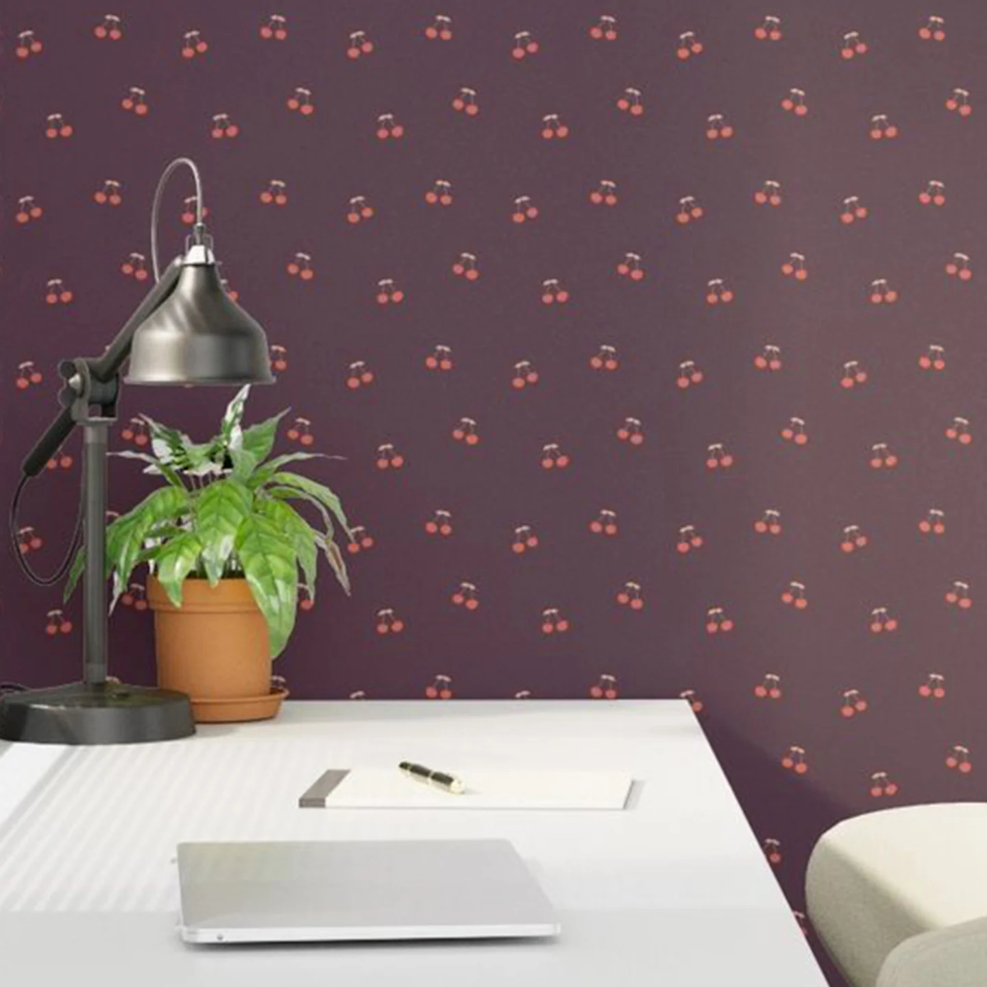 Desk area with maroon cherry wallpaper.