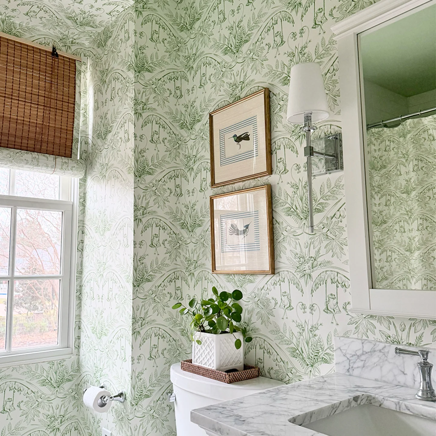 Green and cream frog toile wallpaper in a bathroom.