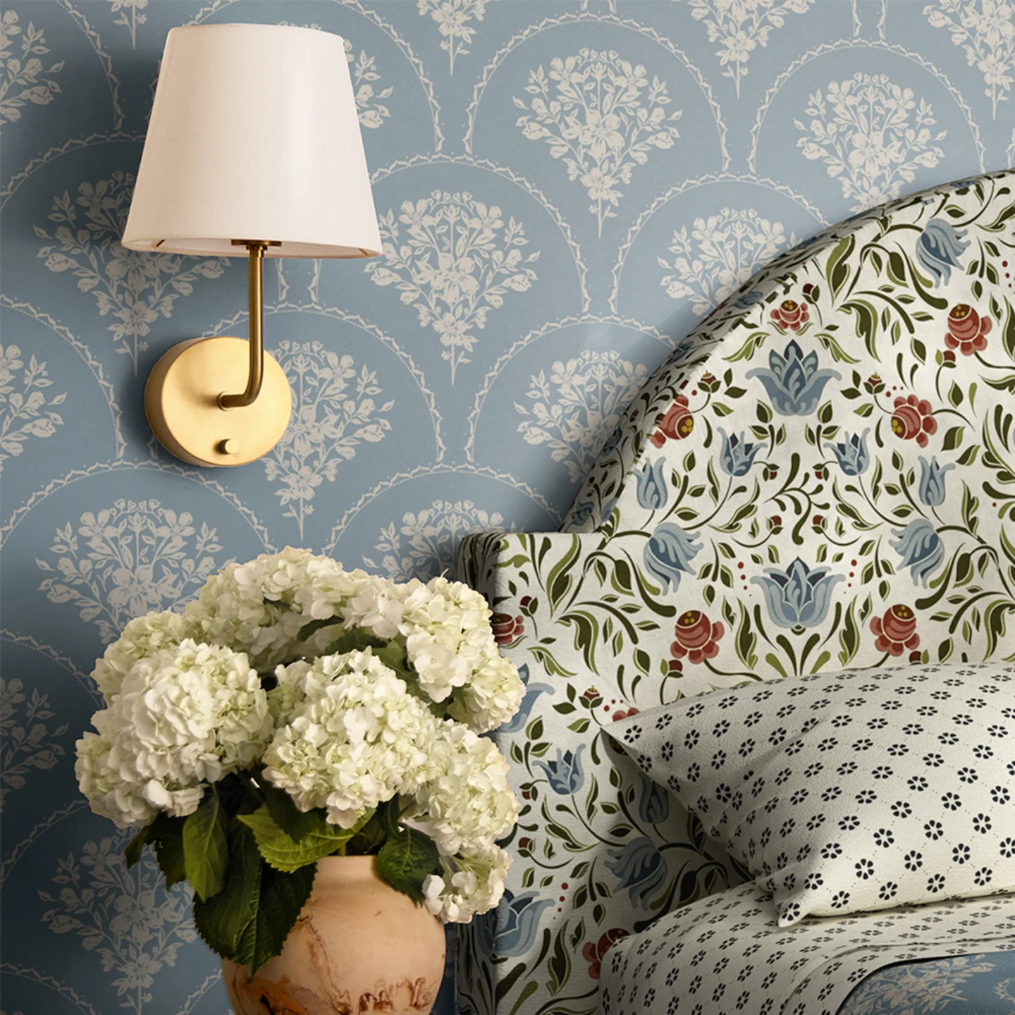 Bedroom with blue floral scallop wallpaper and coordinating headboard and bedding.