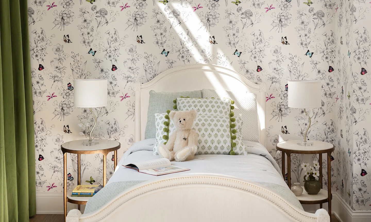 Girls bedroom with white butterfly and floral wallpaper.
